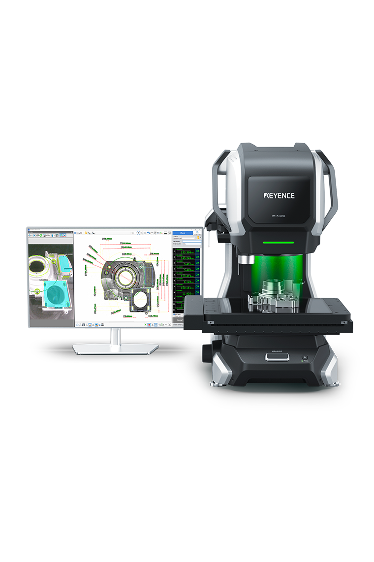 The IM-X measurement system next to a monitor displaying a part's image, drawing overlay, and a measurement list with OK results.