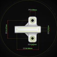A small bracket-shaped part with several dimension measurements overlaid in green, each numbered and labeled in millimeters.